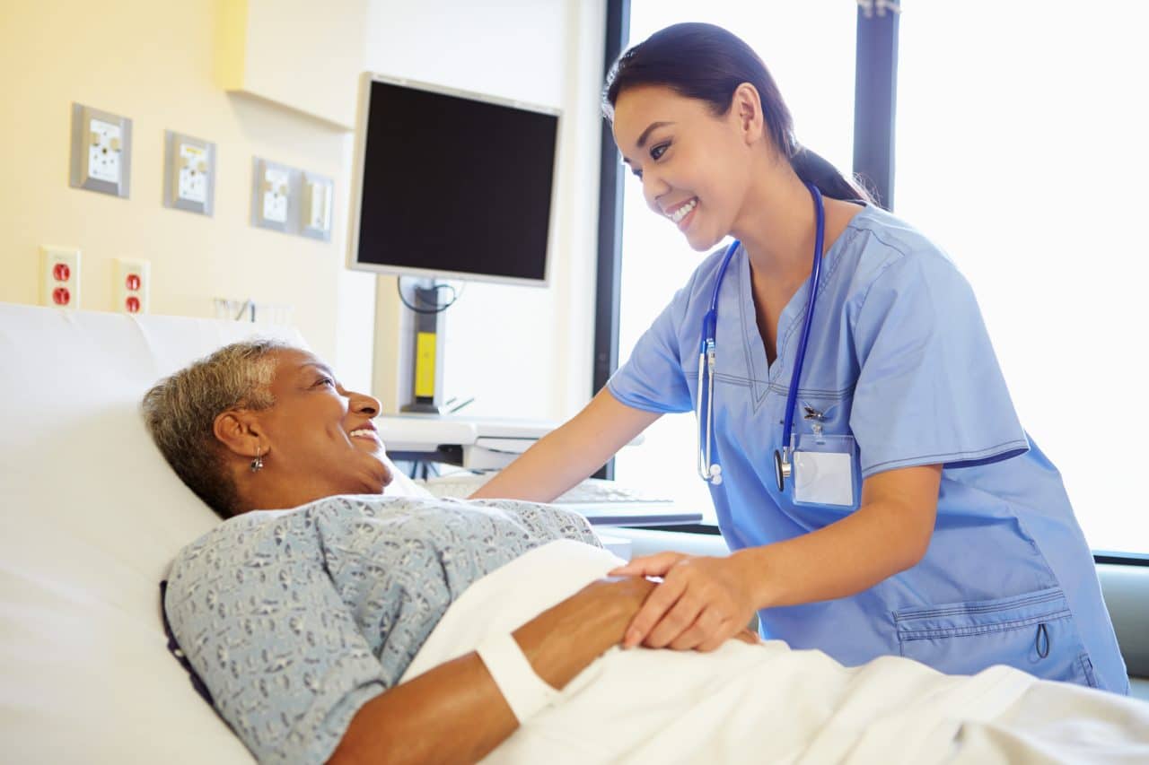 Nurse talking to a patient in the hospital.