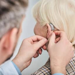 Woman getting fitted for a hearing aid.