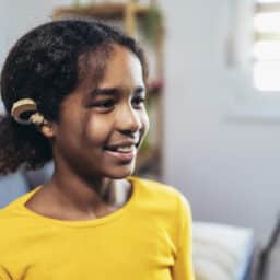 Young girl wearing a hearing aid