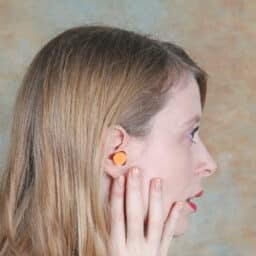 Side view of a woman wearing earplugs