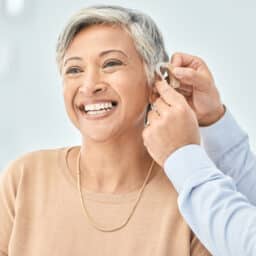 Woman gets hearing aid adjusted