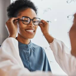 Woman trying on new glasses at the eye doctor