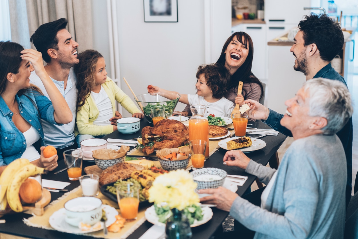 Happy family enjoying Thanksgiving dinner.