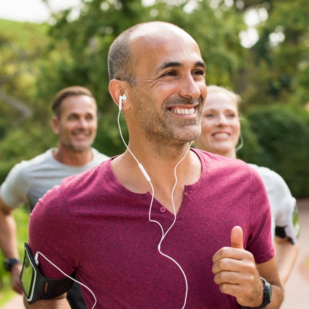 Man with CIC hearing aids wears headphones while working out. 